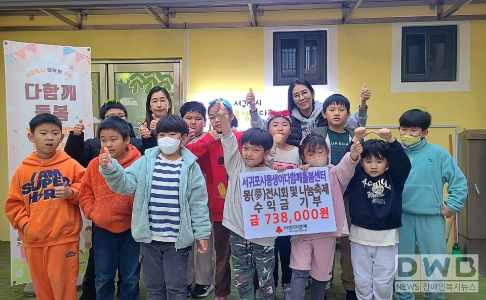 서귀포시몽생이다함께돌봄센터 직원들과 아이들이 기념촬영을 하고 있다.